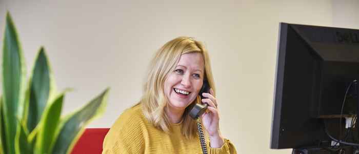 Admissions colleague working behind a desk