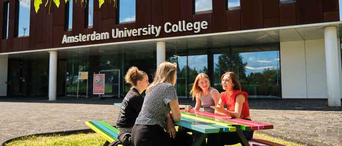 Students studying at a table outside of AUC